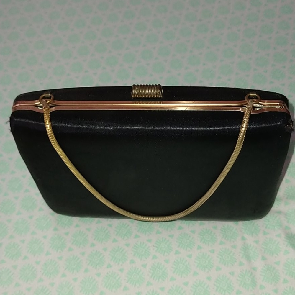 Purse is black with gold chain handle